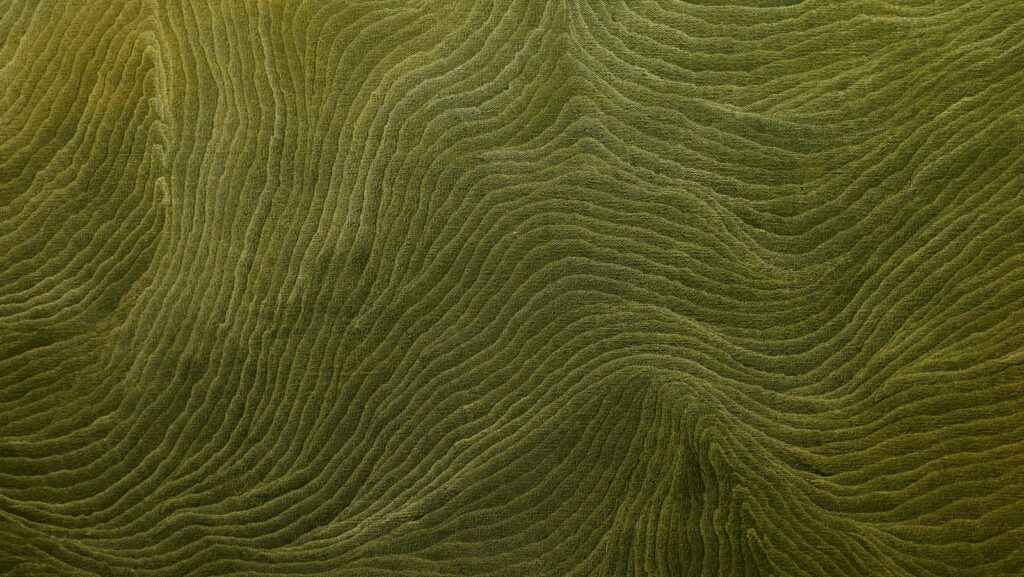 a close up view of a green surface with wavy lines