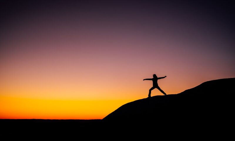 shillouette photo of person standing at the peak representing freedom and flexibility