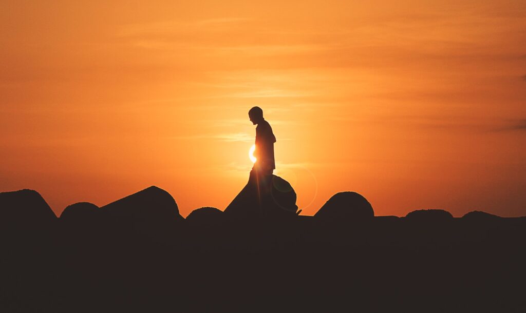 person standing on rock platform representing self management