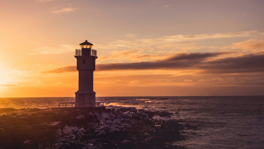 white lighthouse tower under yellow and white cloudy skies at sunset: a guide to employment law and legislation, right to disconnect