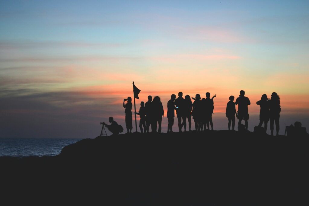 silhouette photography of people gathered together on cliff: Manager
