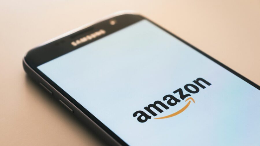 black Samsung Galaxy smartphone displaying Amazon logo: Amazon vs trade union over pay dispute