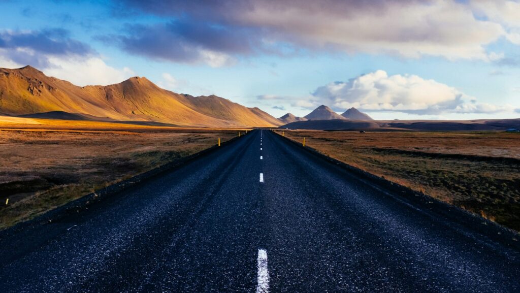 black concrete road with distance to mountains. 2025 people strategy.