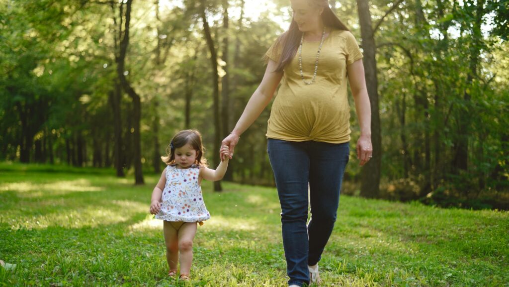 pregnant woman walking beside girl: Maternity policy