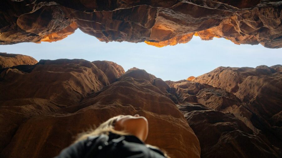 a person looking out from a cave in the desert Equal Pay Day