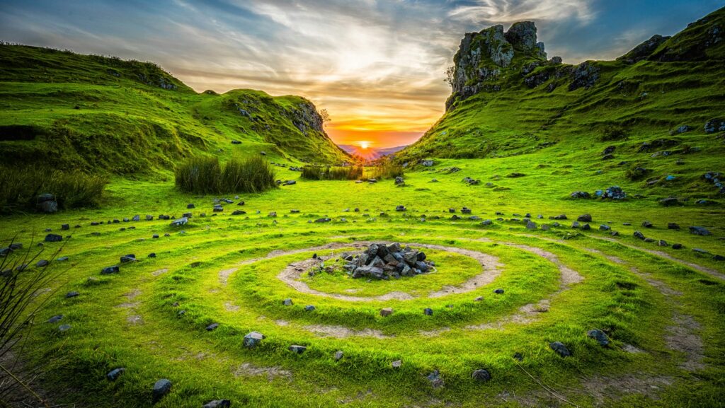 green grass field during sunset,