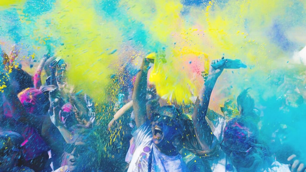 people holding pouches with colored powders,