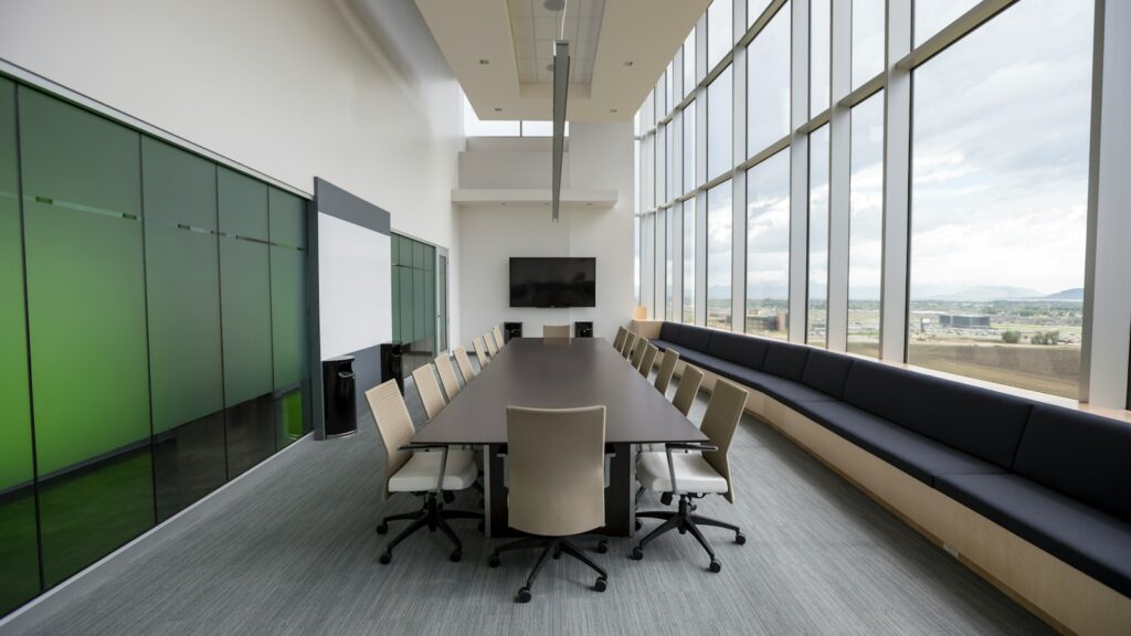 rectangular brown wooden table with chair lot inside building, office