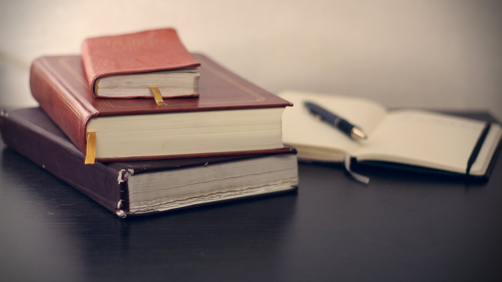 selective focus photography of three books beside opened notebook, employment law