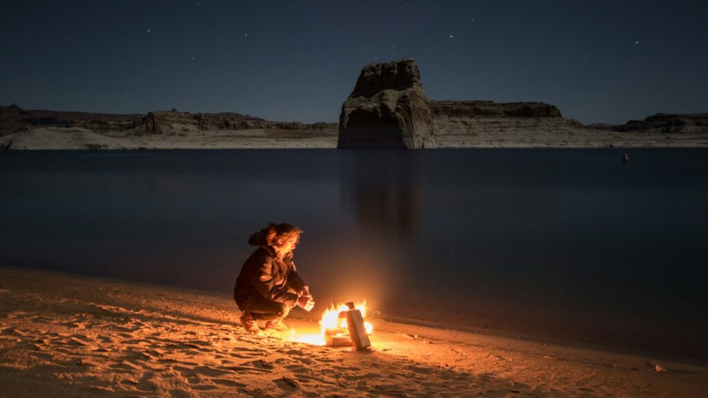 person sitting beside bonfire on seashore, HR burnout