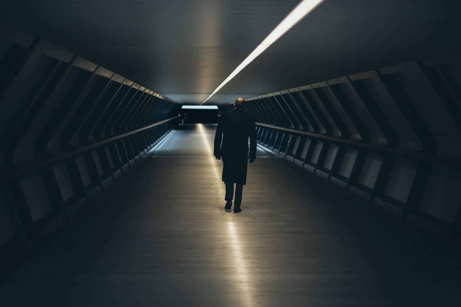 person wearing black long-sleeved shirt walking on tunnel, AI revolution