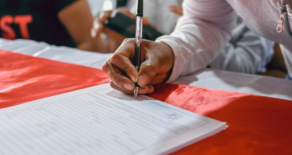 a person writing on a piece of paper