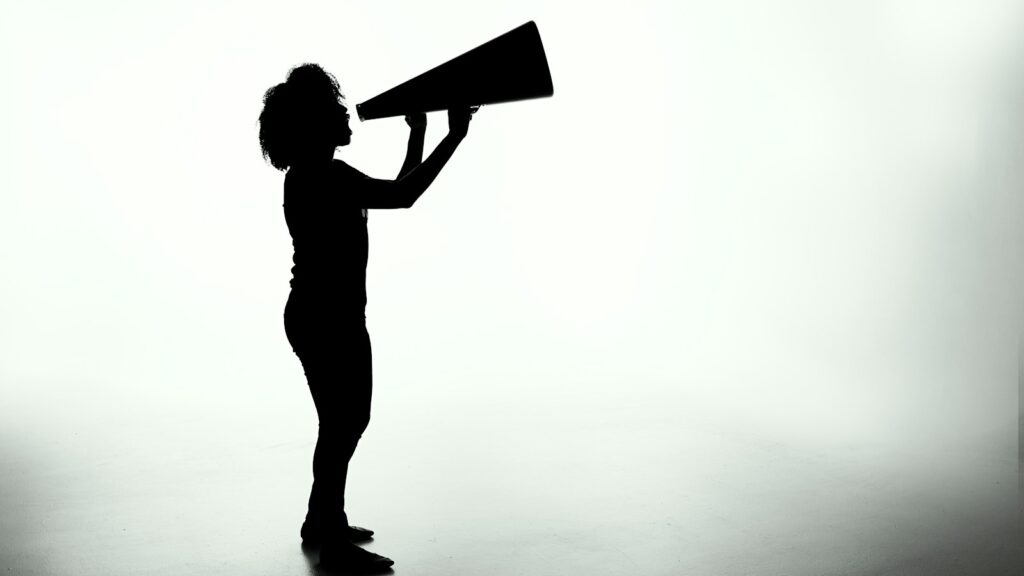silhouette of woman holding rectangular board