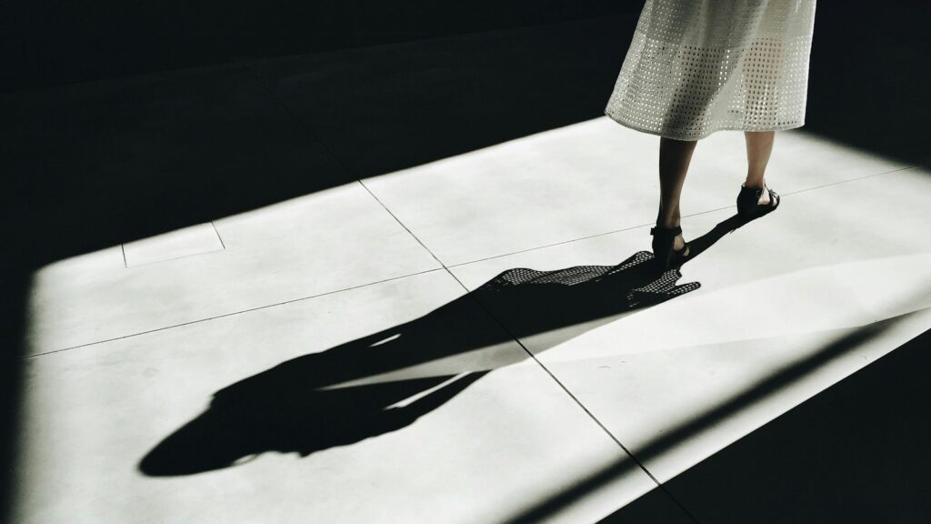 woman walking with shadow, depicting shadow AI trend.