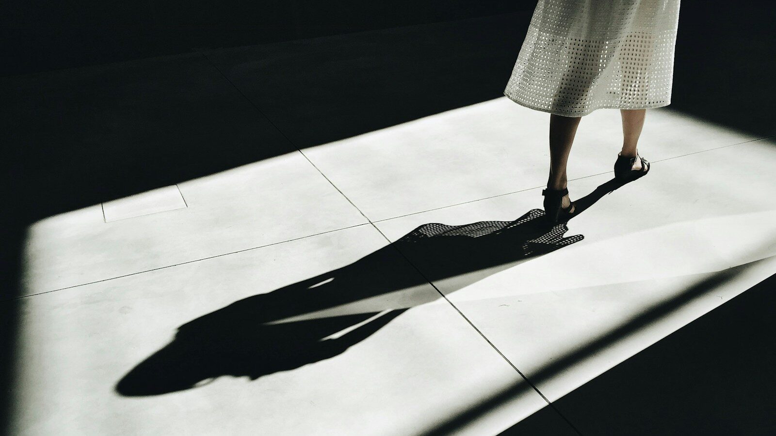 woman walking with shadow, depicting shadow AI trend.