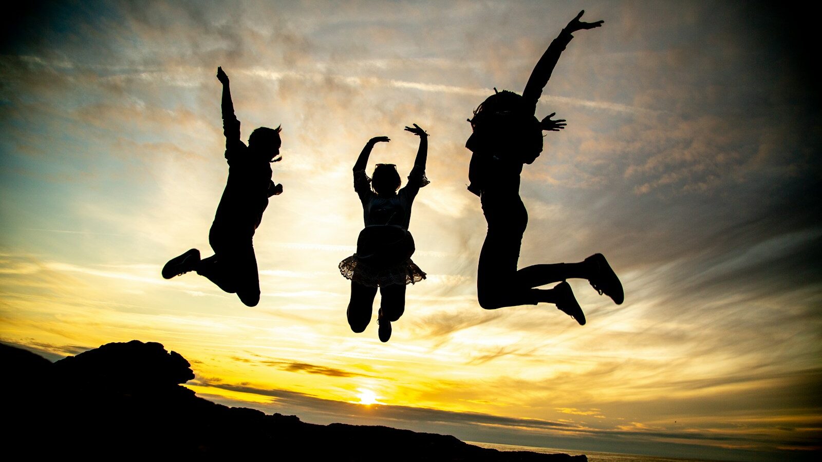 silhouette of jumping people, depicting Gen Alpha