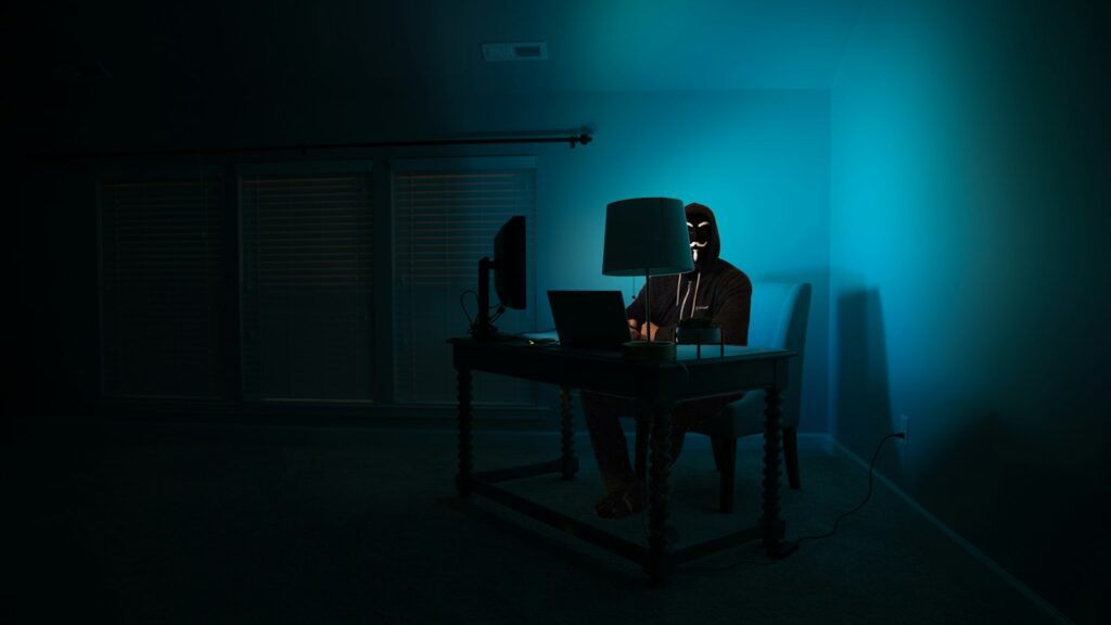 man siting facing laptop