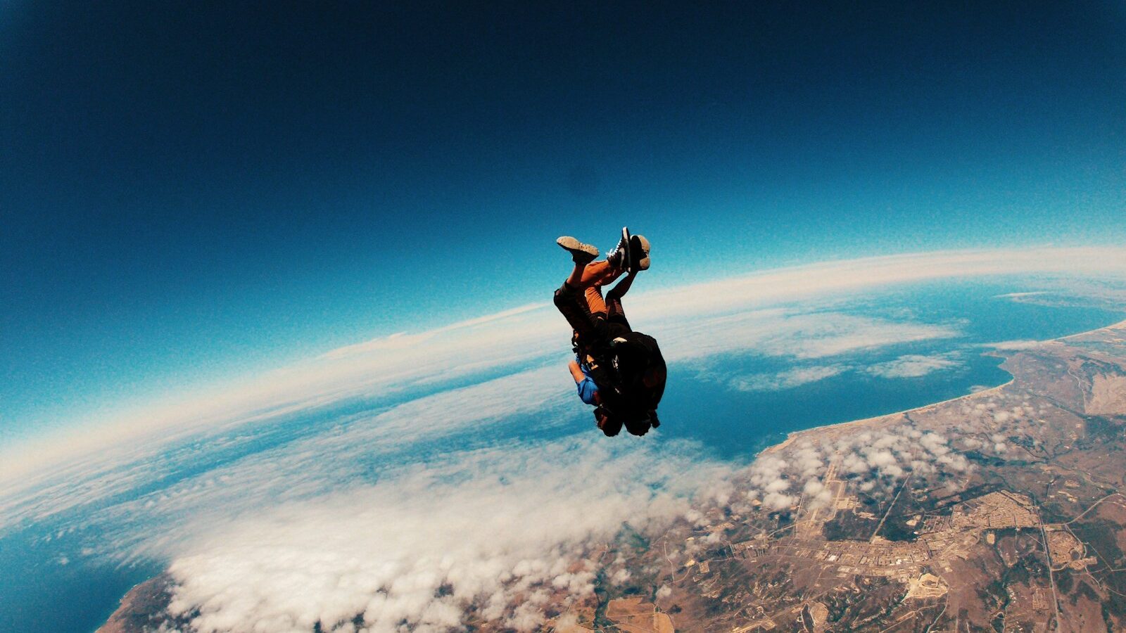 person skydiving on air during daytime, Tesla DEI director, courage over fear