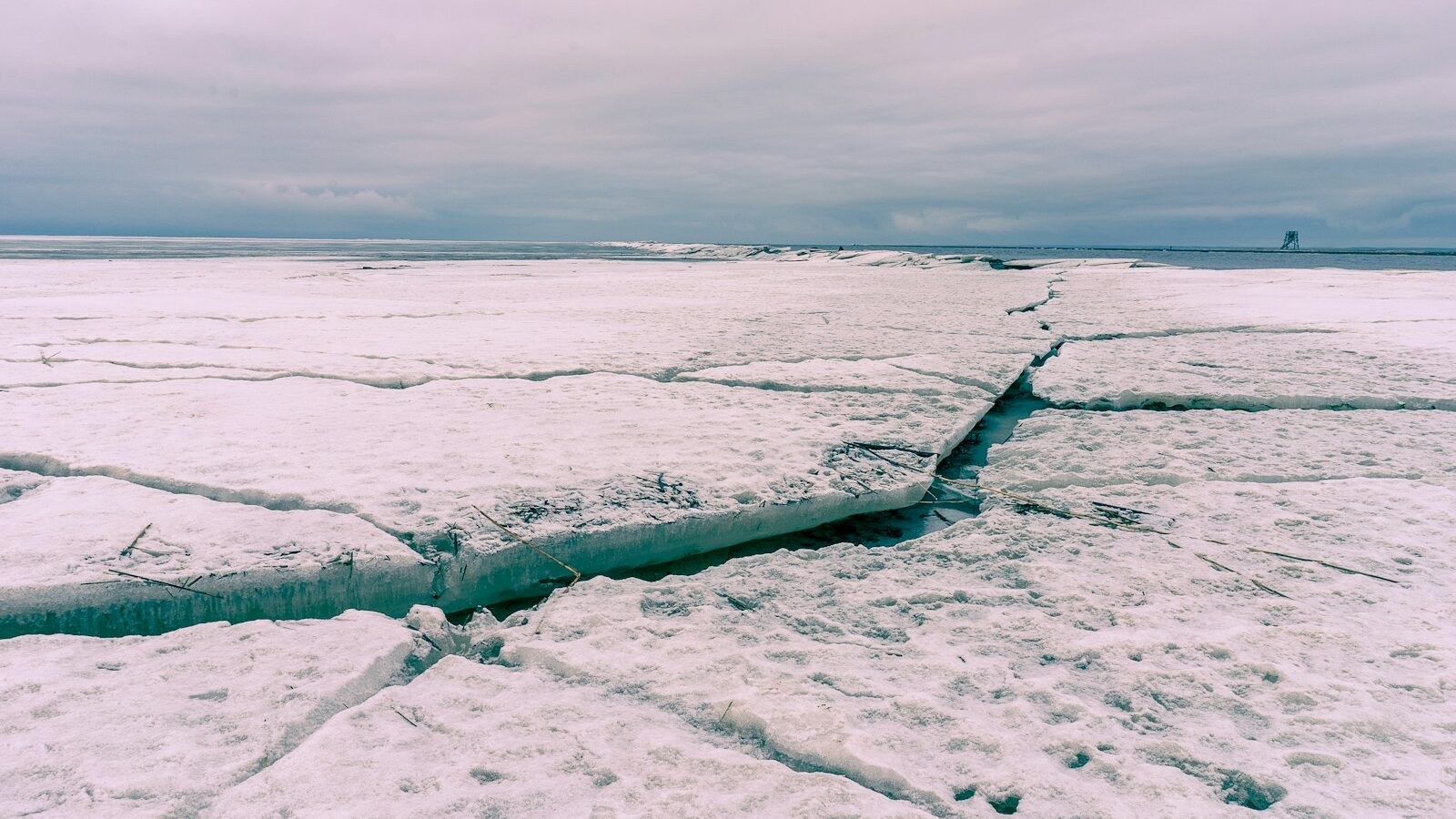 A crack in the ice on a frozen lake, depicting quiet cracking buzzword.