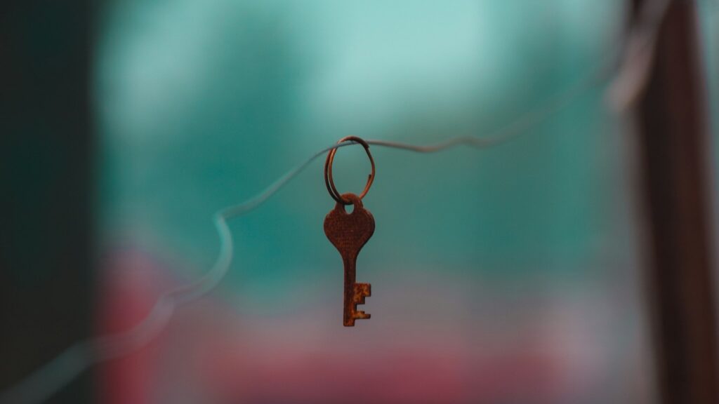 brown key chain with black and red background